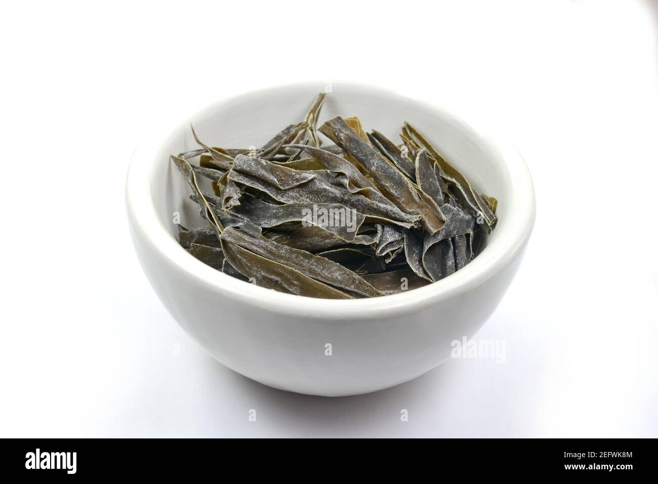 Dried kombu seaweed in a white bowl. Dried kombu seaweed Japanese dry