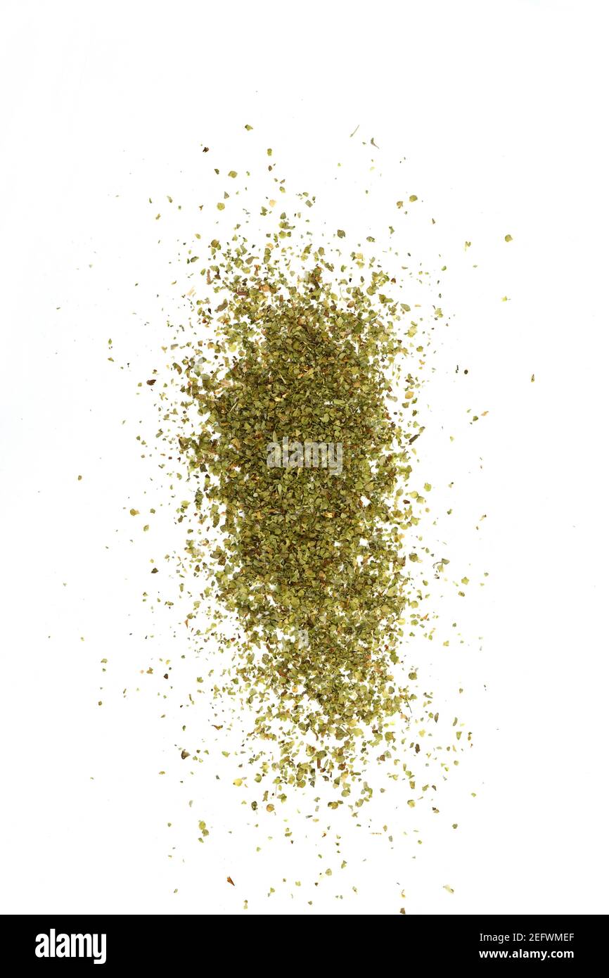 Dry marjoram spice (Origanum majorana). Heap of ground marjoram leaves isolated on white Stock