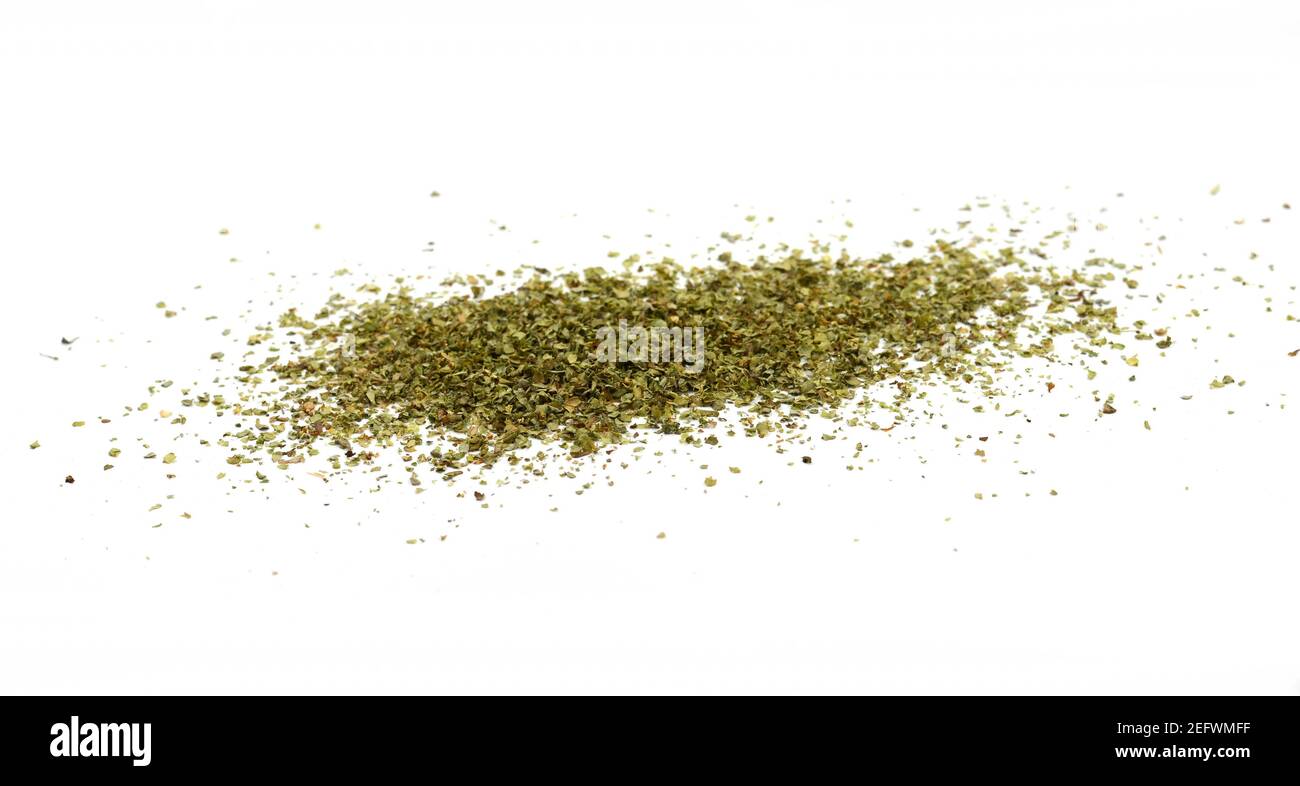 Dry marjoram spice (Origanum majorana). Heap of ground marjoram leaves isolated on white Stock