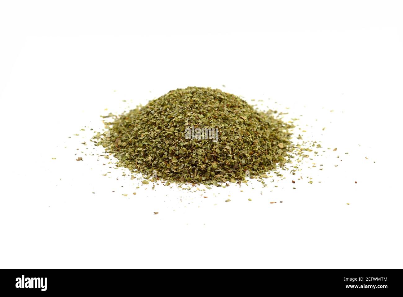 Dry marjoram spice (Origanum majorana). Heap of ground marjoram leaves isolated on white Stock