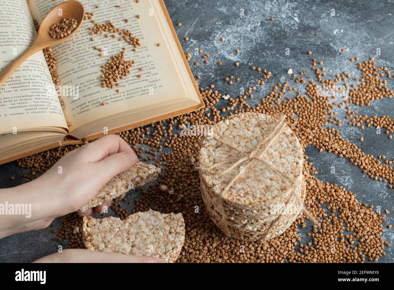 Female hands splitting rice cake on marble surface Stock Photo Alamy
