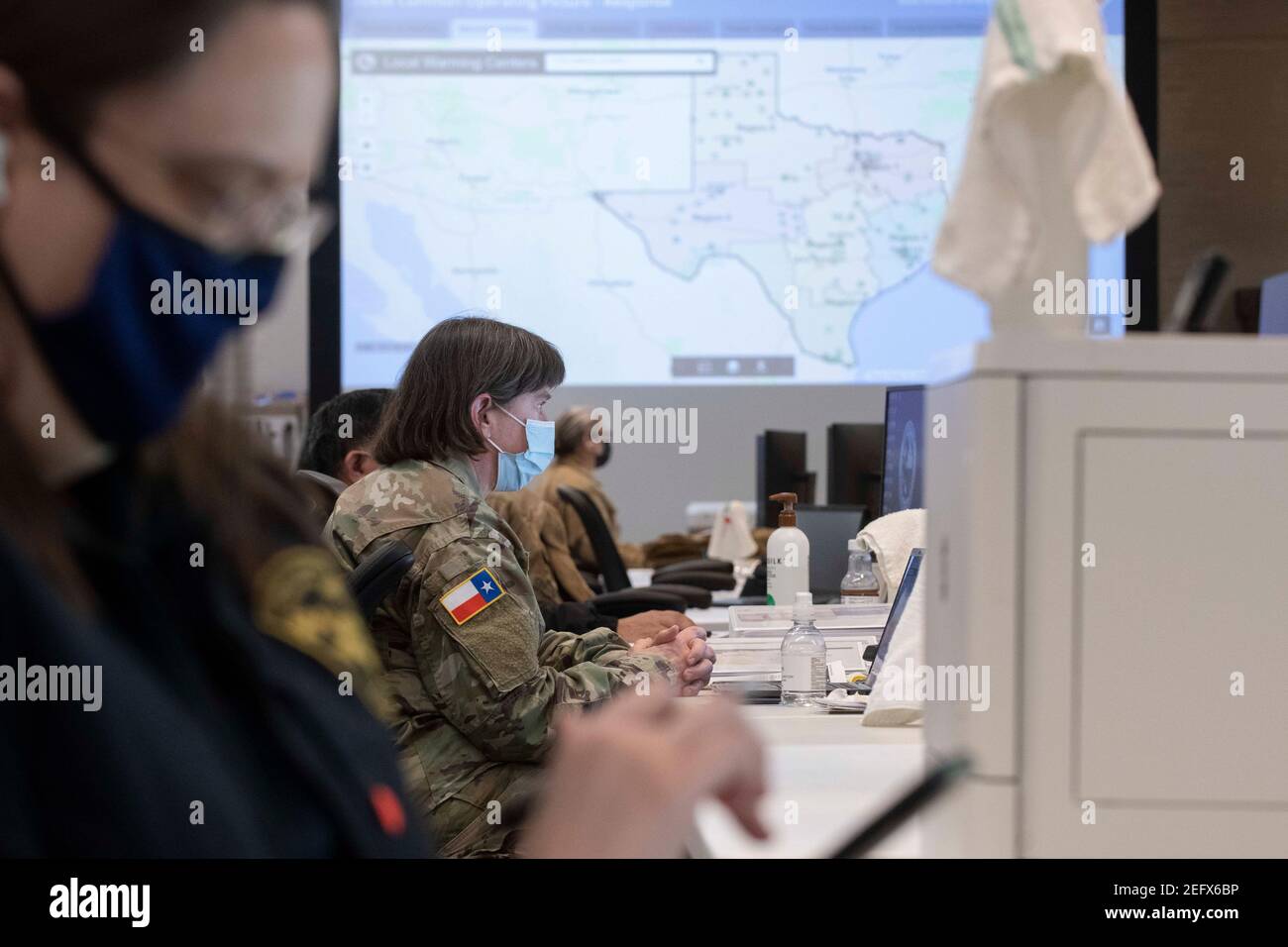 Austin, Usa . 17th Feb, 2021. Austin, Texas Feb 17, 2021: Emergency officials including Margaret Vaughn of the Texas State Guard monitor the Texas weather in the State Operations Center, part of the Texas Division of Emergency Management, while Texas deals with record snow and bitter cold in all 254 counties. About a quarter of the state is still without power as officials deploy state resources on a multitude of fronts. Credit: Bob Daemmrich/Alamy Live News Stock Photo