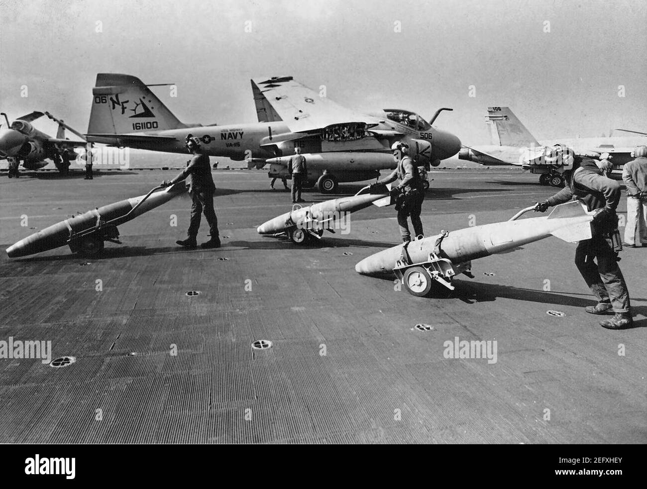 Ordnancemen push bombs on flight deck of USS Midway (CV-41) in 1991. Stock Photo