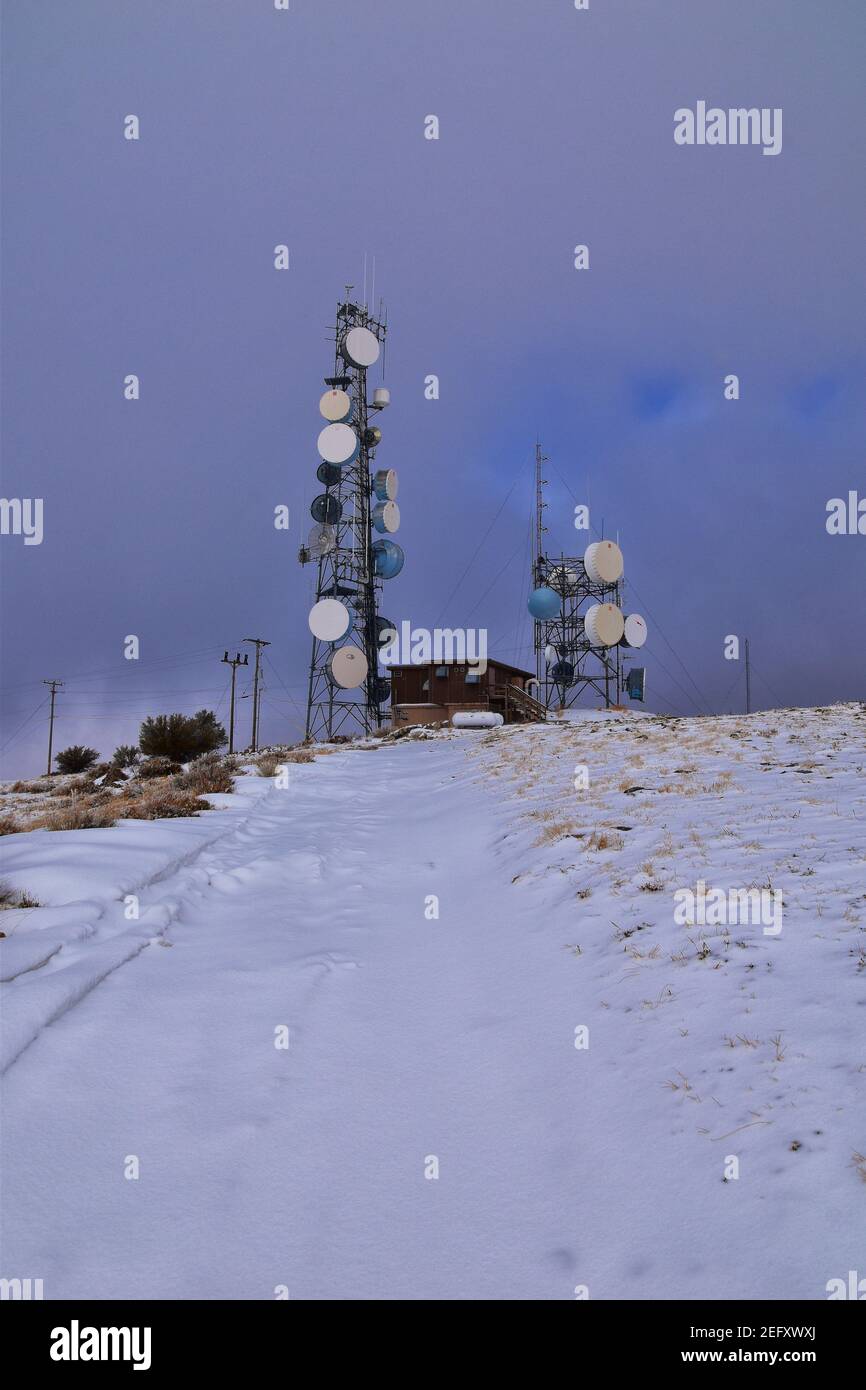 Radio Towers on Lake Mountains Peak via Israel Canyon road in winter, Utah Lake, Wasatch Front Rocky Mountains, Provo, United States. Stock Photo