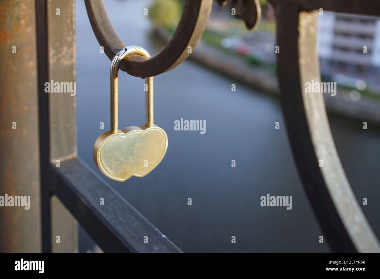 Metal lock symbol of love on the metal fence of the bridge Stock Photo ...