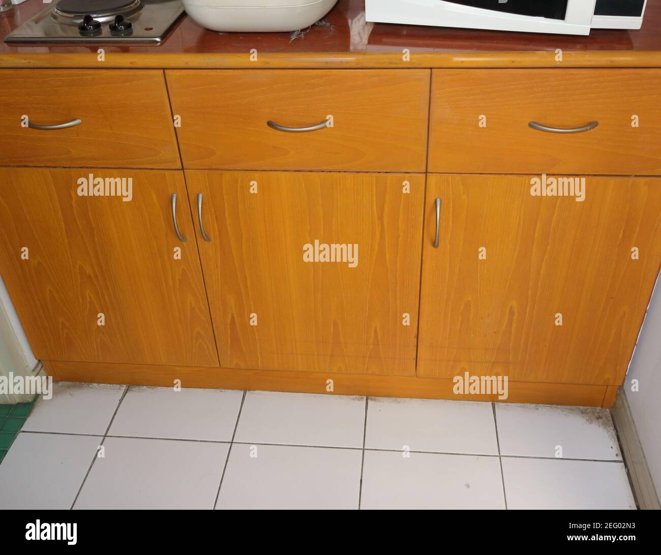 High angle view of built-in kitchen cabinet made from teak plywood, with laminated plastic countertop Stock Photo