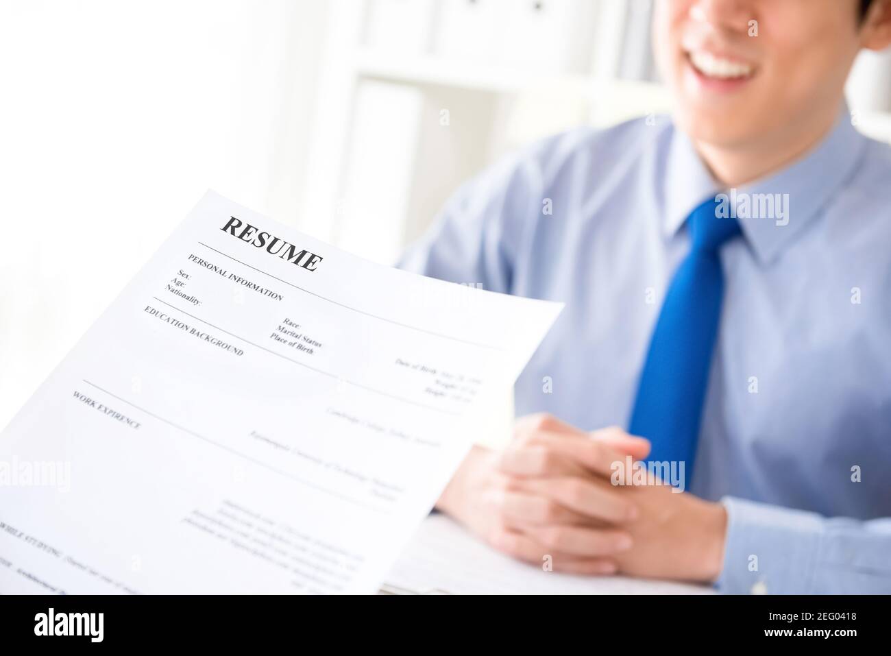 Young businessman submitting resume to employer to review  - job application and interview concepts Stock Photo