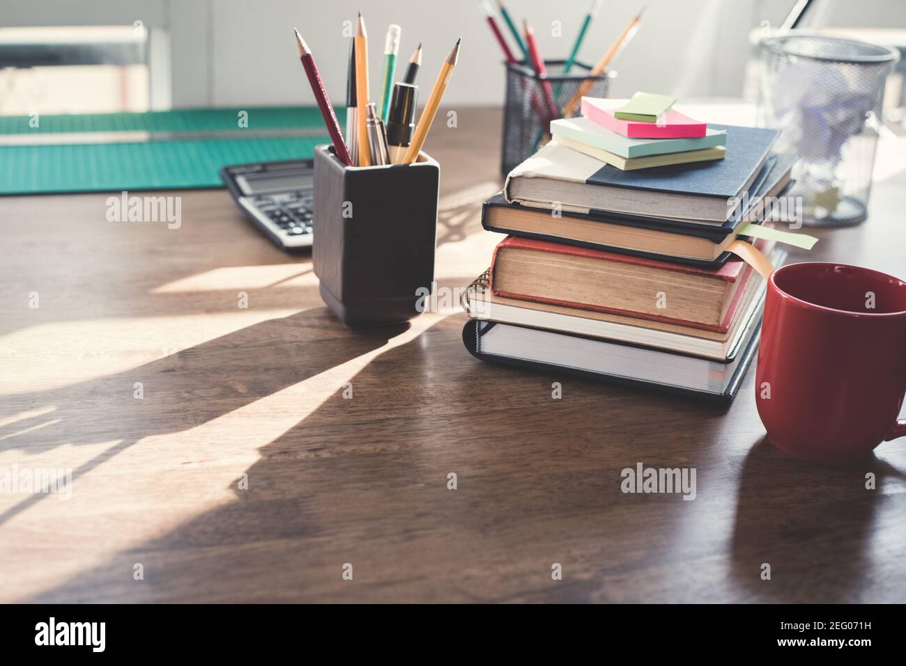 Stack of books and stationery on wood table Stock Photo