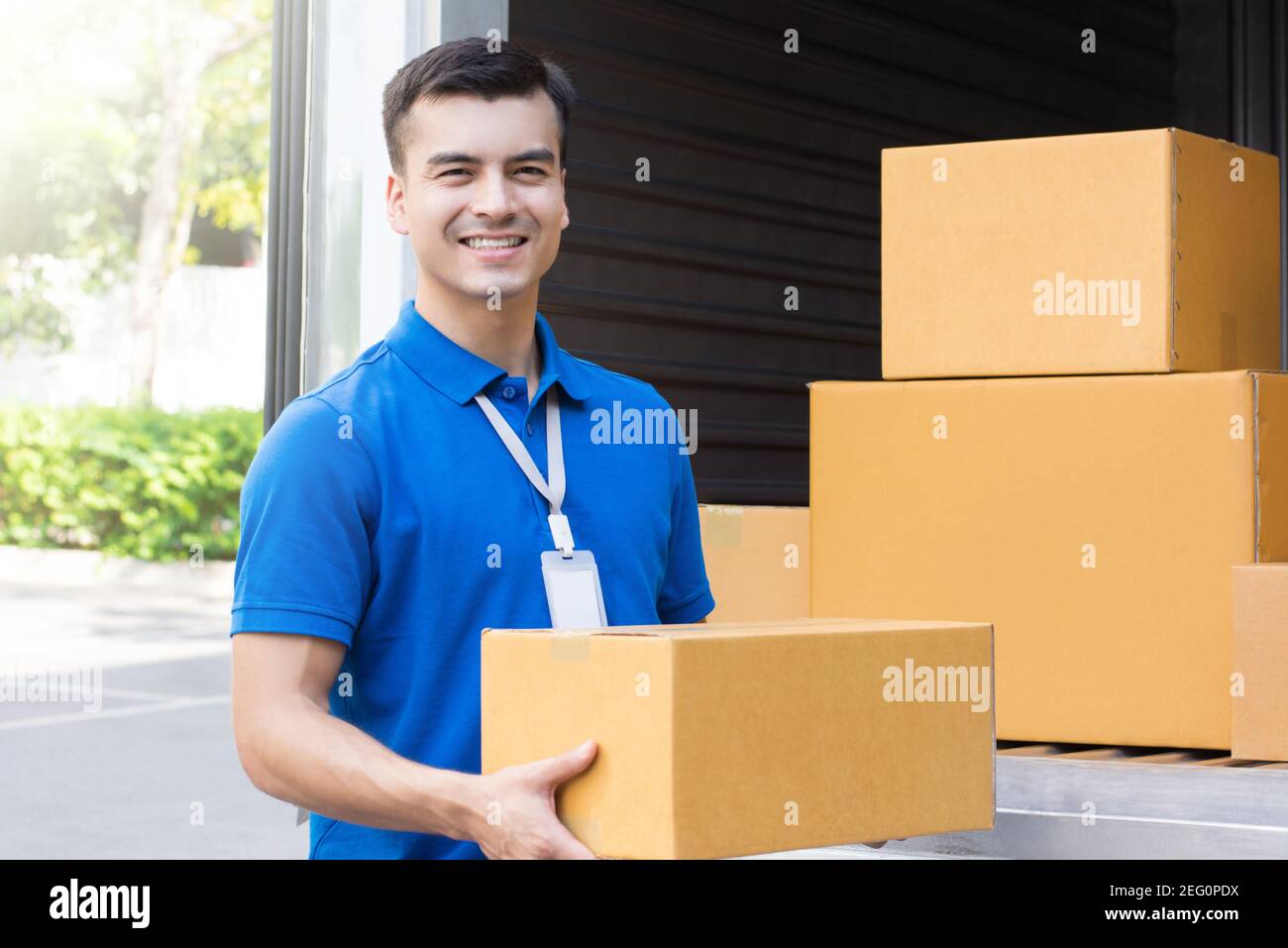 A man carrying  package from delivery car - courier service concept Stock Photo