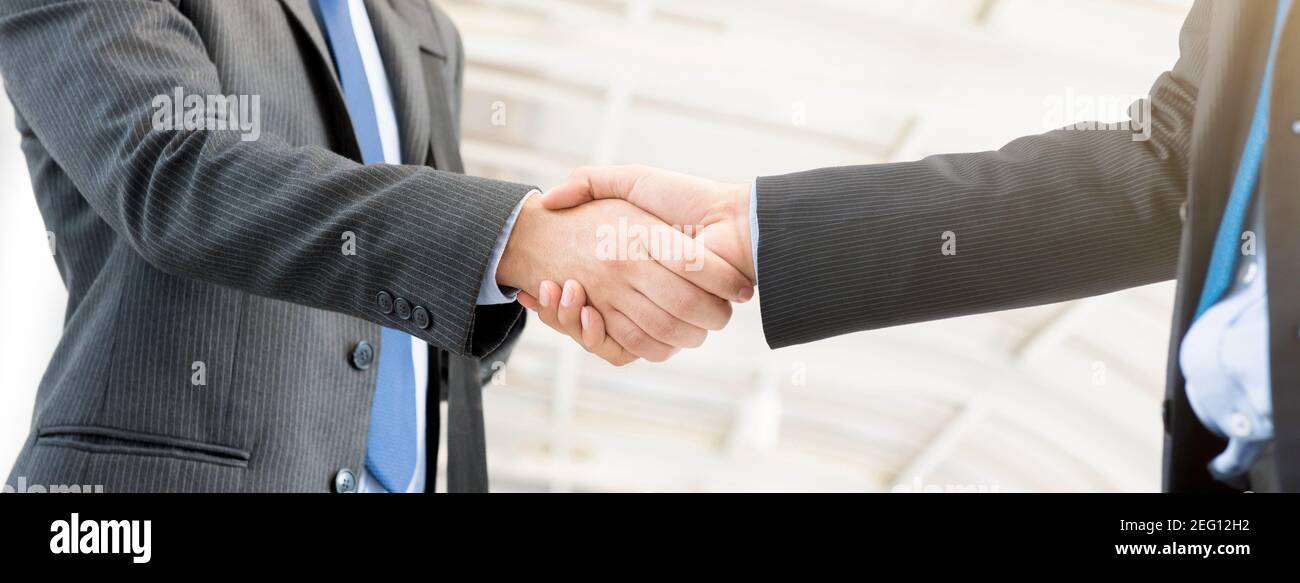 Businessmen making handshake, panoramic banner Stock Photo Alamy