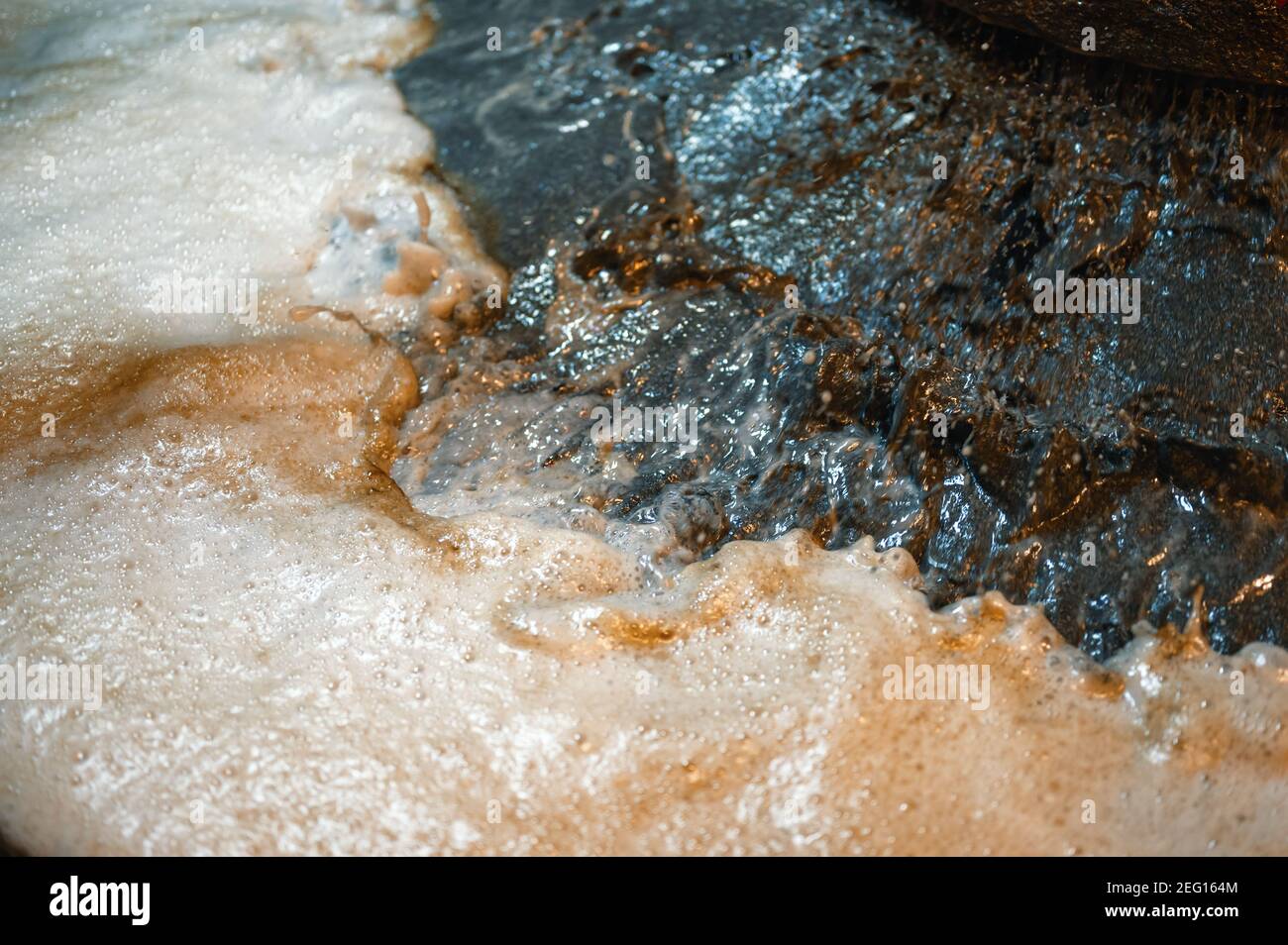 Industrial flotation process. Shooting closeup. The stream of liquid