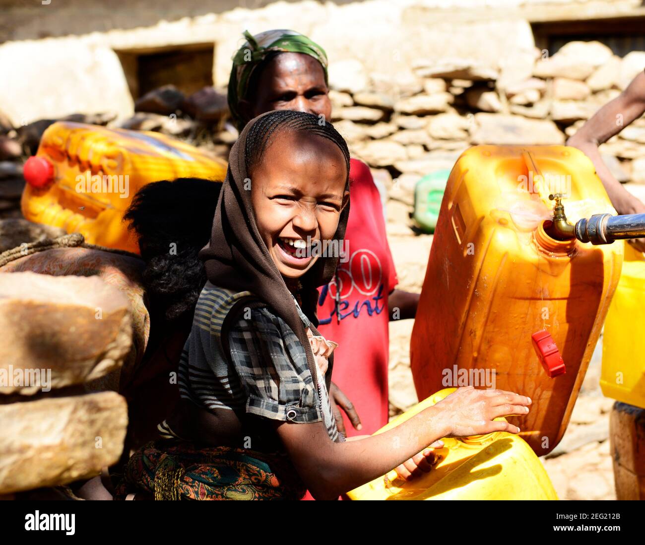 Local Tigrayans filling jerrycans of water in their village water pump