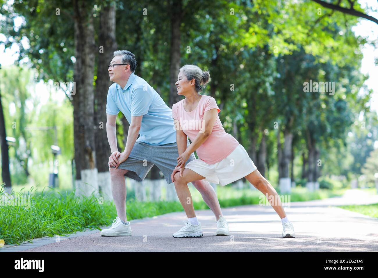 Old couple doing exercising in the park Stock Photo