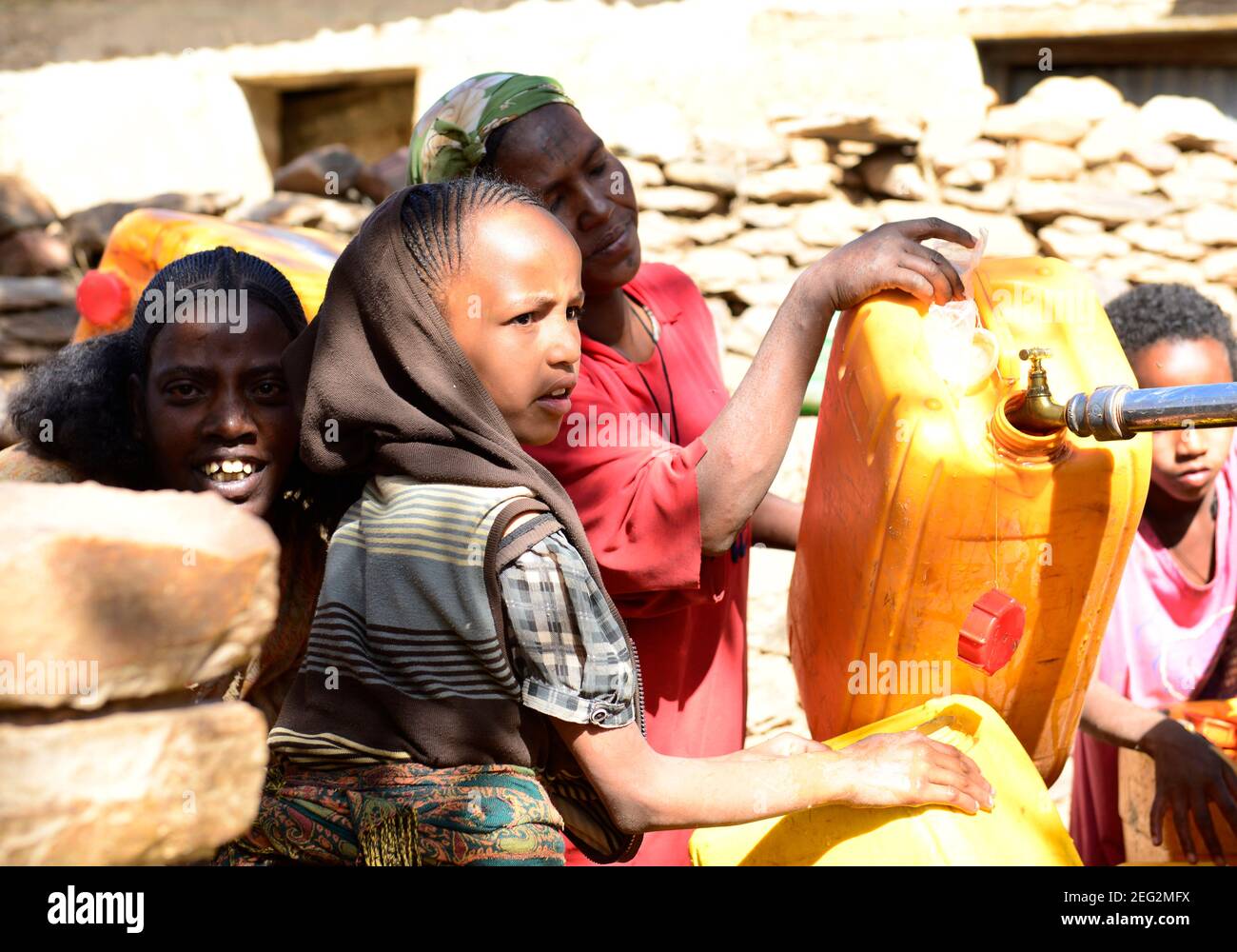 Local Tigrayans filling jerrycans of water in their village water pump