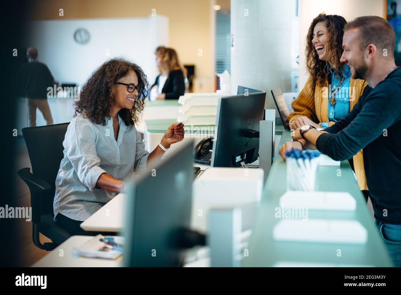 People standing at municipal office reception and talking to a