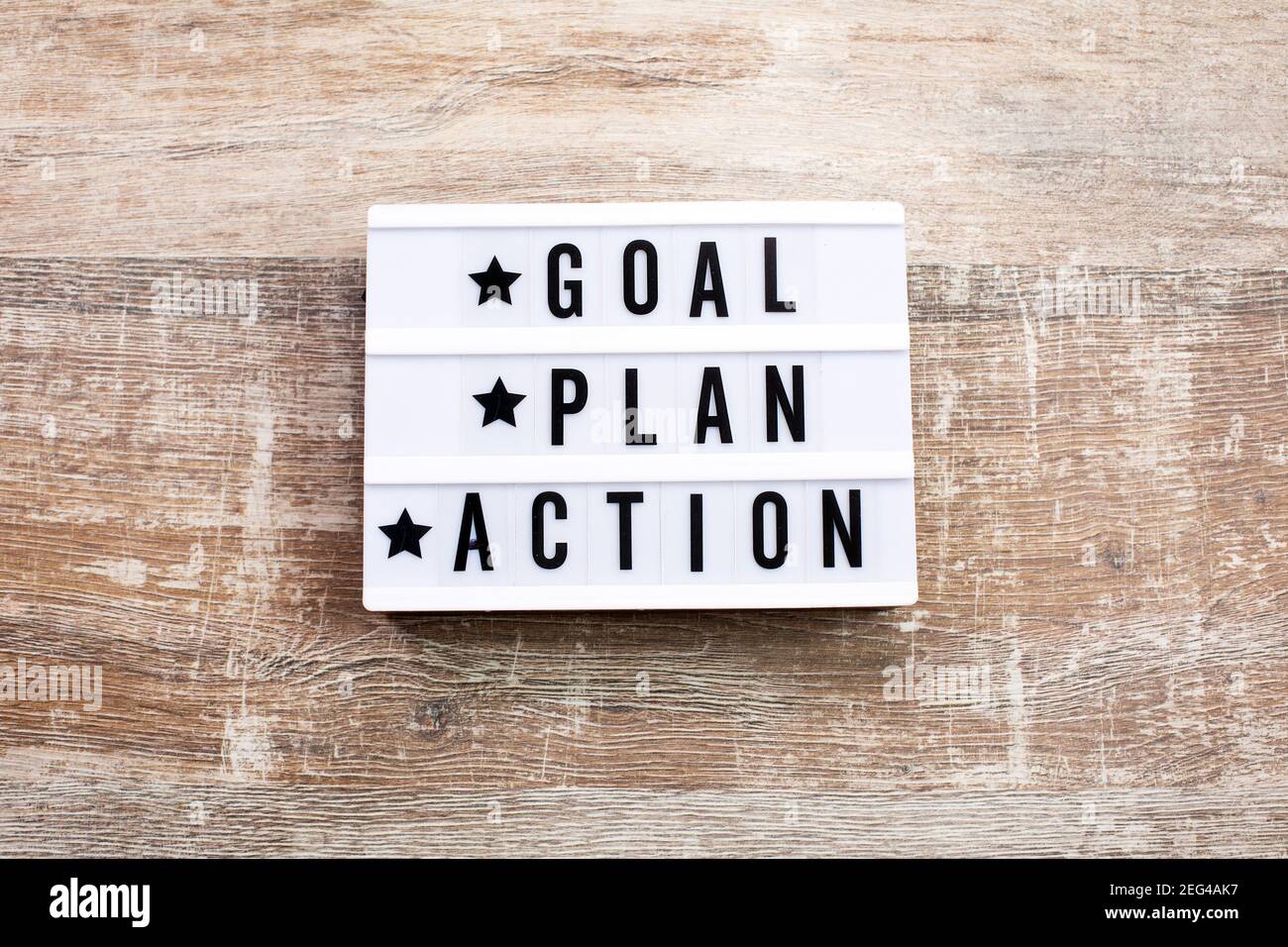 Goal, Plan, Action text on light box on wooden table. Business ...
