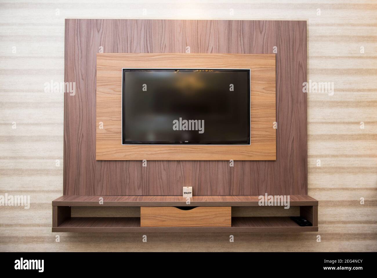 Smart TV in a wooden wall in a cozy apartment Stock Photo