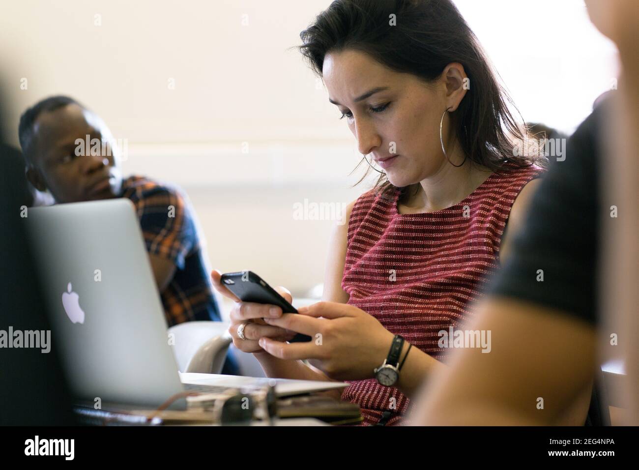 Student using smartphone while searching for online ideas Stock Photo