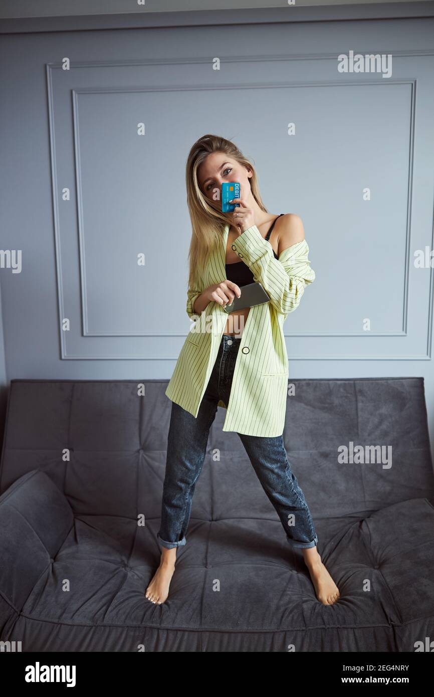 Woman Presenting Blue Debit Card Before Her Face Stock Photo Alamy