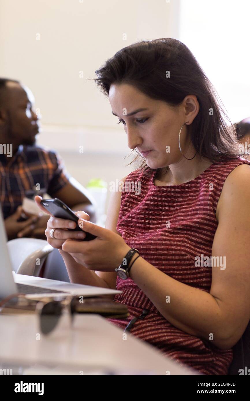 Student using smartphone while searching for online ideas Stock Photo