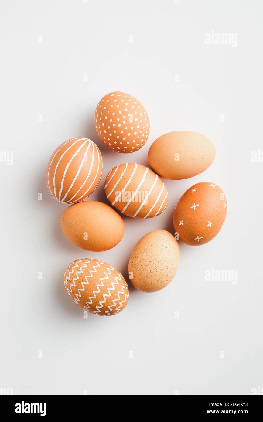 Modern Easter eggs on white background. Flat lay, top view. Simple, nordic style. Stock Photo