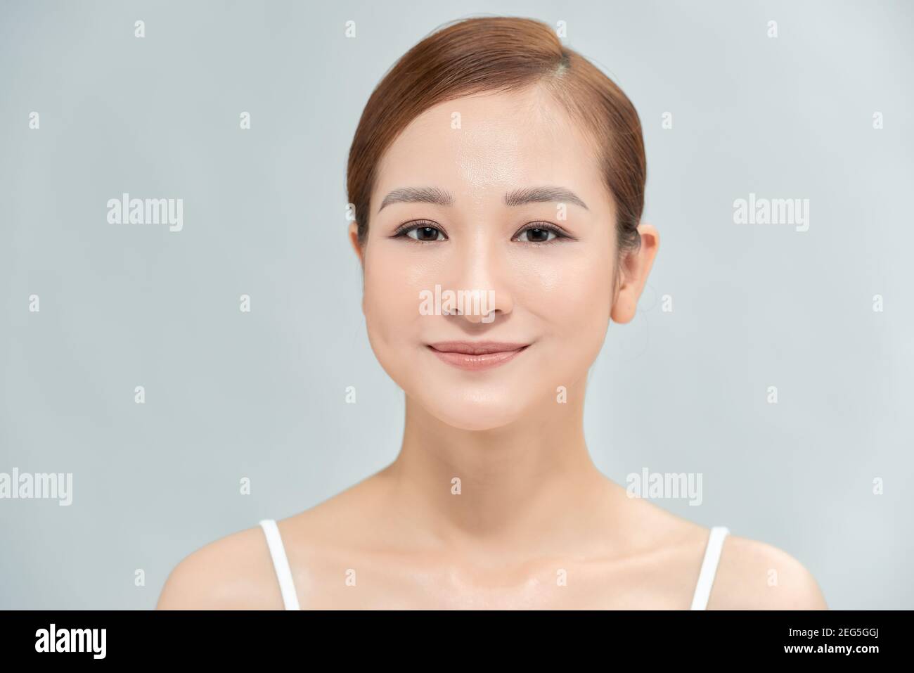 Charming beautiful young asian woman touching face Stock Photo - Alamy