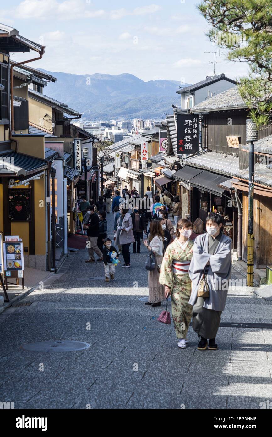 Visitors walking along Ninenzaka, or Ninen-zaka, a preserved pedestrian shopping street in the Higashiyama area of Kyoto, Japan Stock Photo