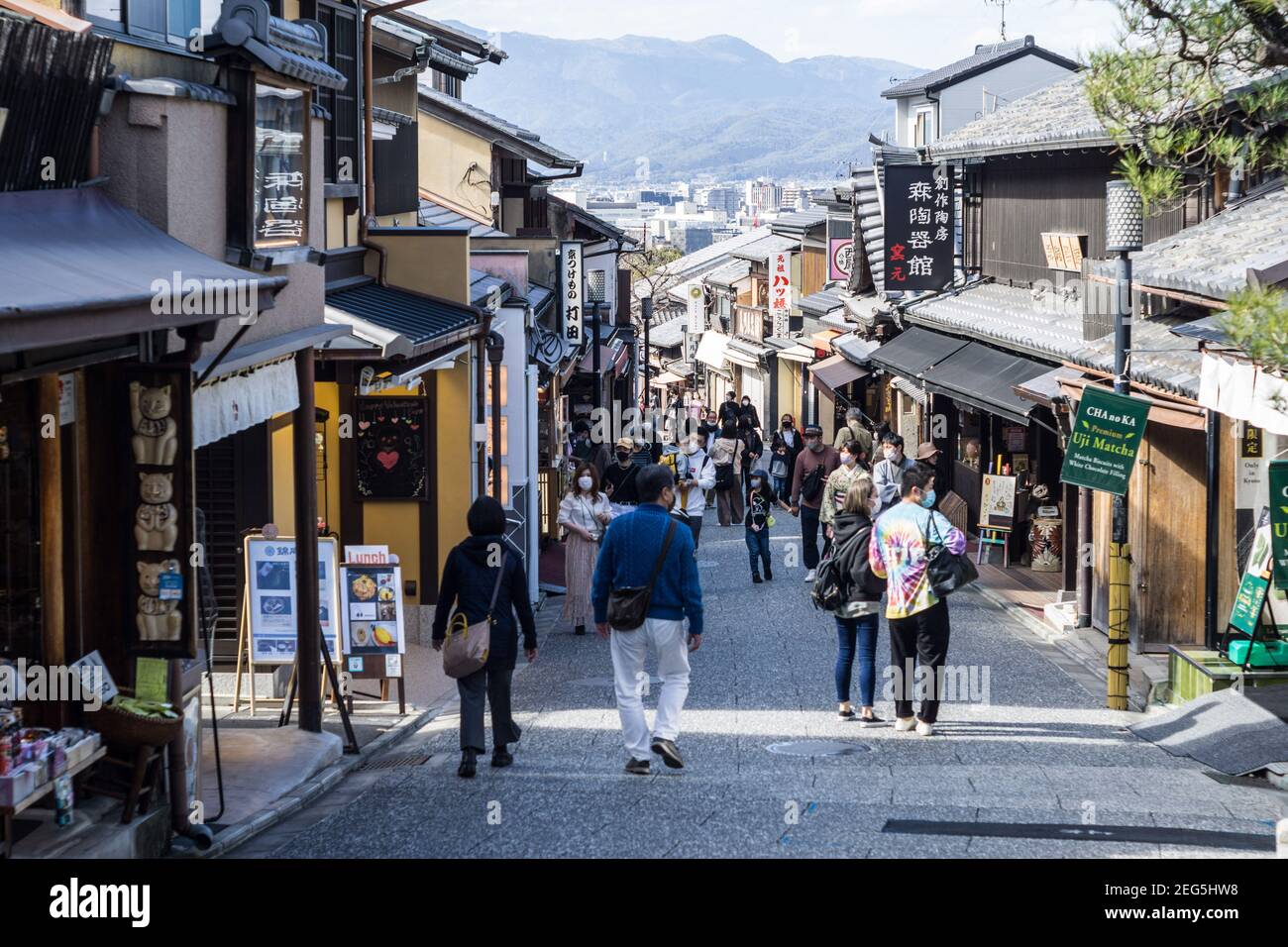 Visitors walking along Ninenzaka, or Ninen-zaka, a preserved pedestrian shopping street in the Higashiyama area of Kyoto, Japan Stock Photo