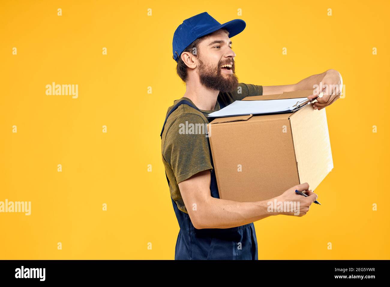 Service Man Images man in professional service uniform yellow background Stock Photo - Alamy