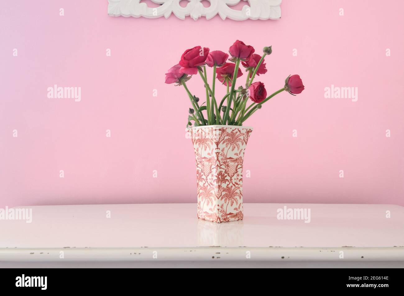 Still Life of Red Roses in Pink & White Vase Set Against Pink