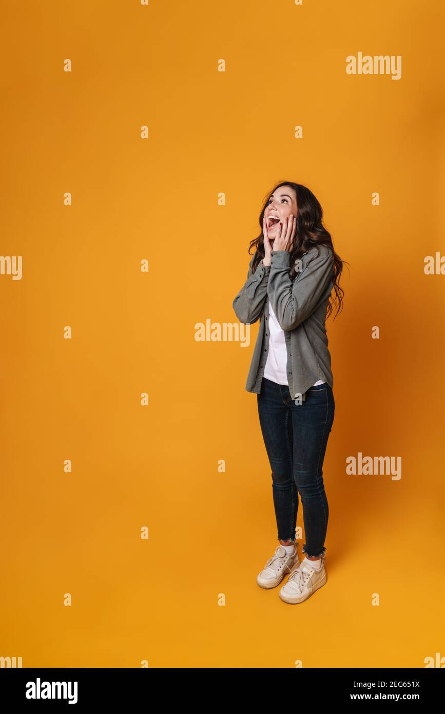 Excited beautiful girl expressing surprise and looking upward isolated ...