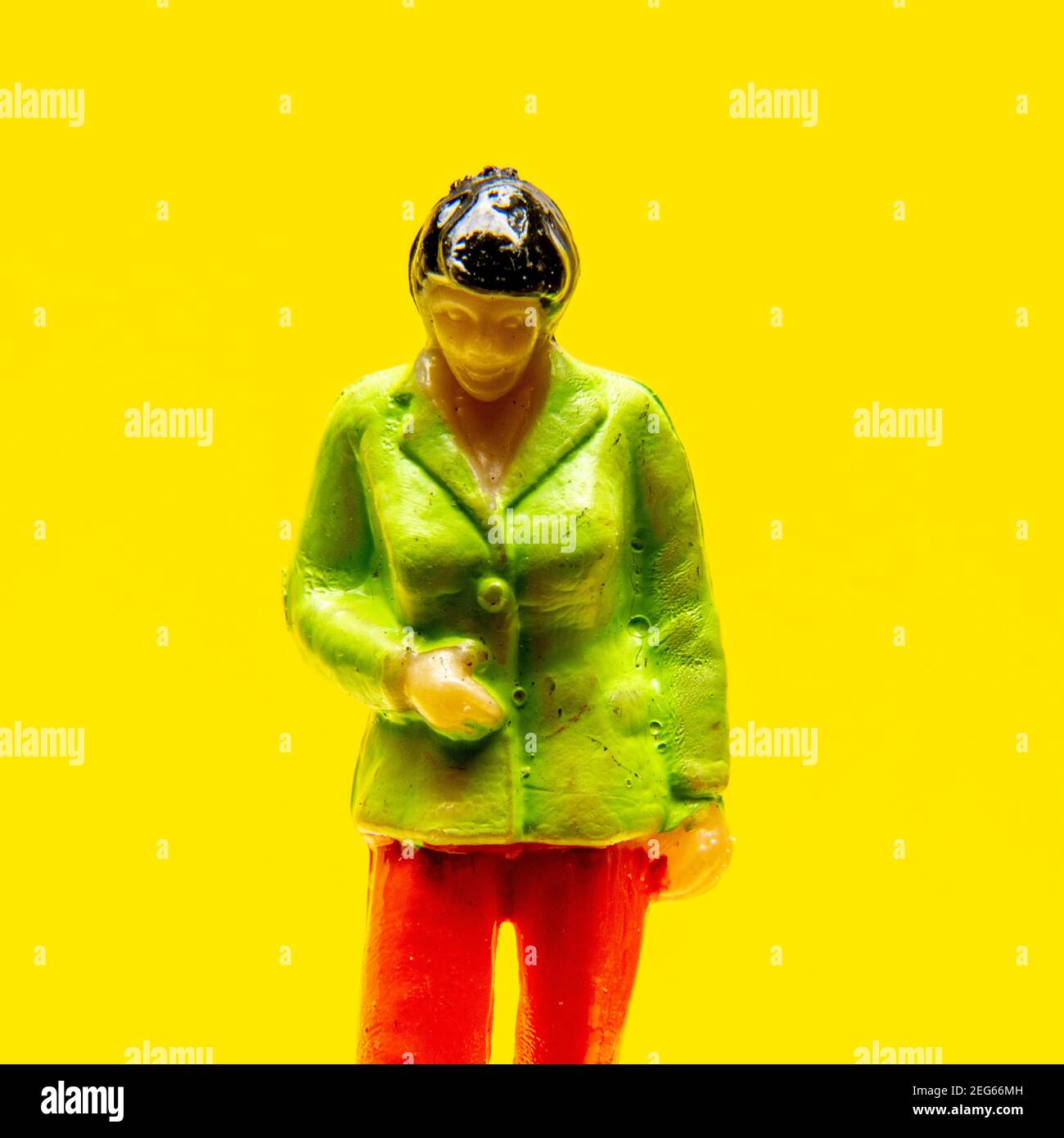 Figurine woman on a yellow background, France Stock Photo