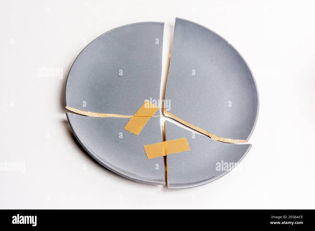 Gray broken plate , studio shot Stock Photo