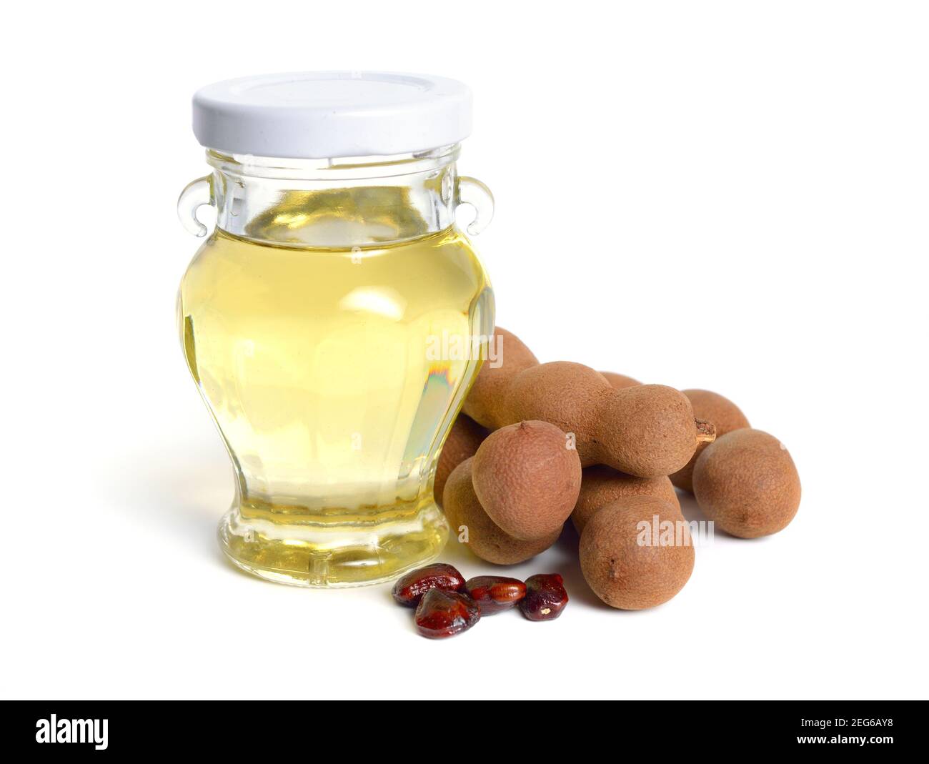 Tamarind oil with fruits and seeds isolated on white background Stock