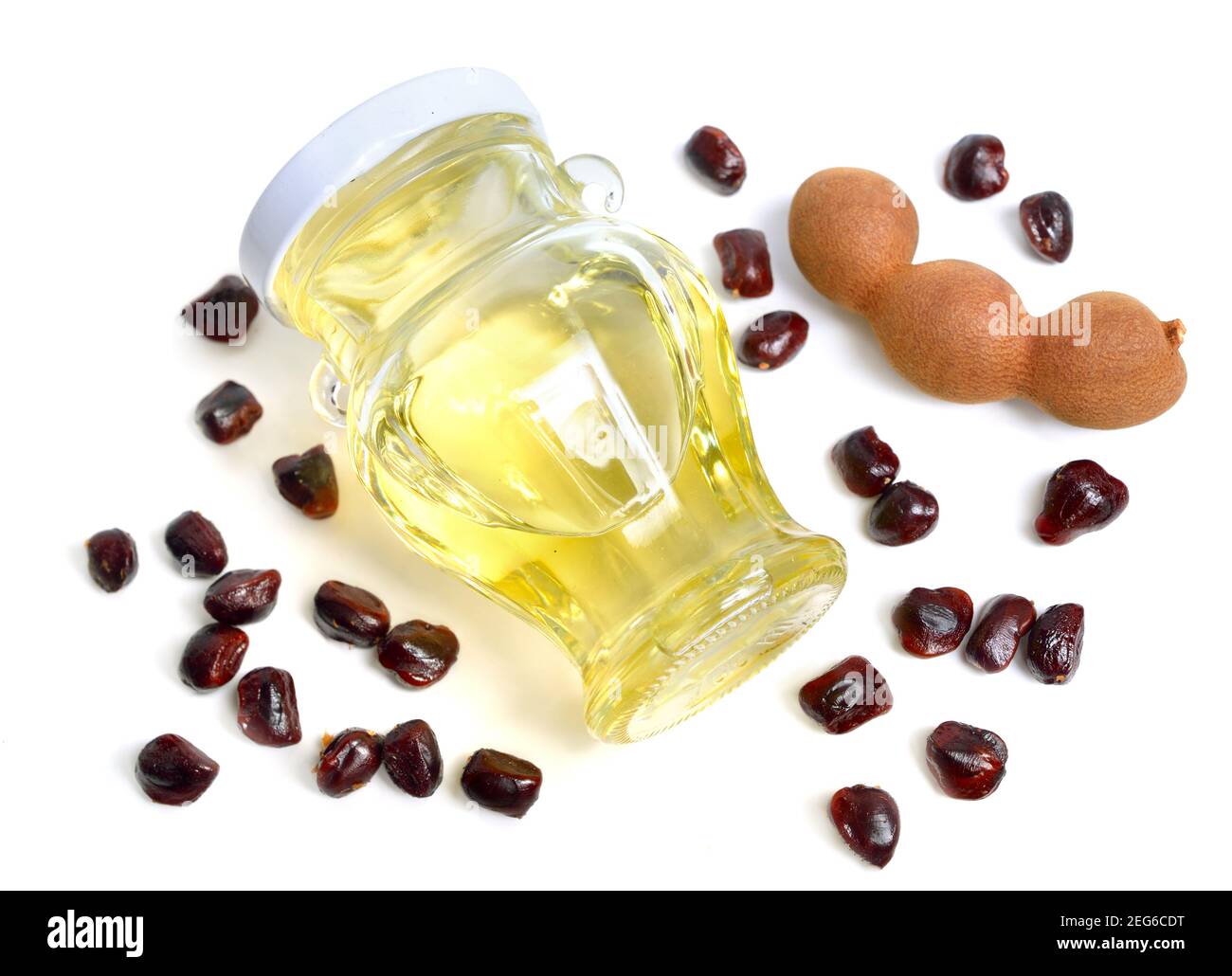 Tamarind oil with fruits and seeds isolated on white background Stock