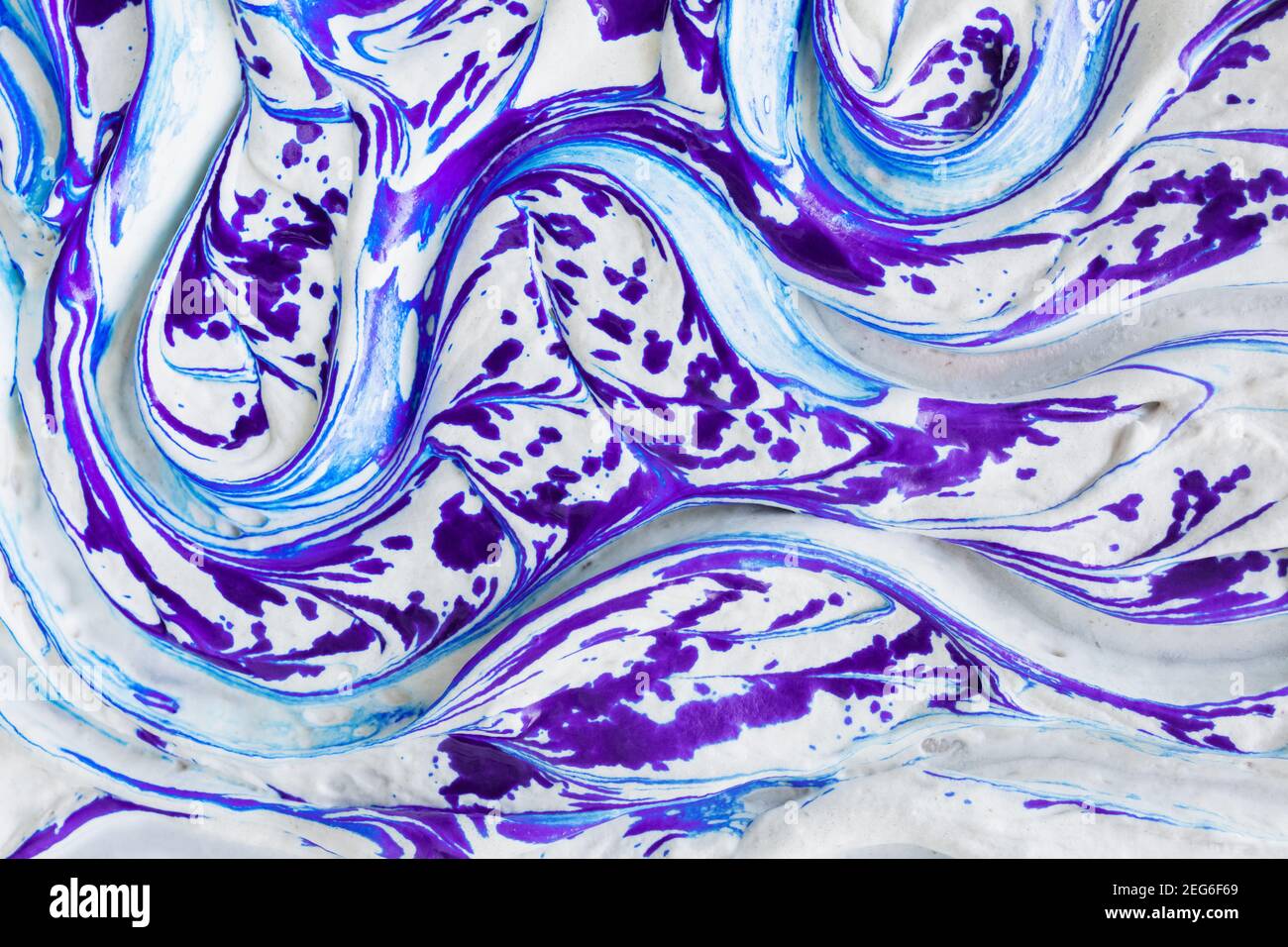 Fluid art artistic liquid marble texture background. White liquid soft cream surface with impressive splashes of violet ink and marble effect with lon Stock Photo