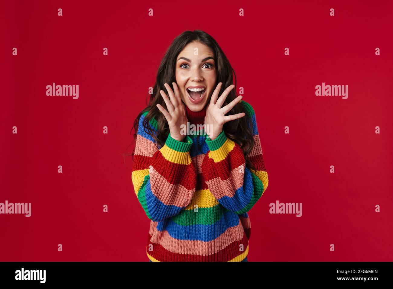 Excited beautiful brunette girl expressing surprise at camera isolated ...