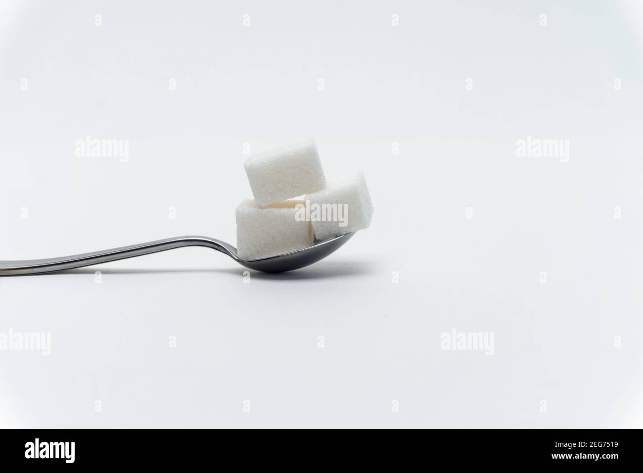 sugar cubes in a teaspoon sweets calorie ingredient Glucose Stock Photo