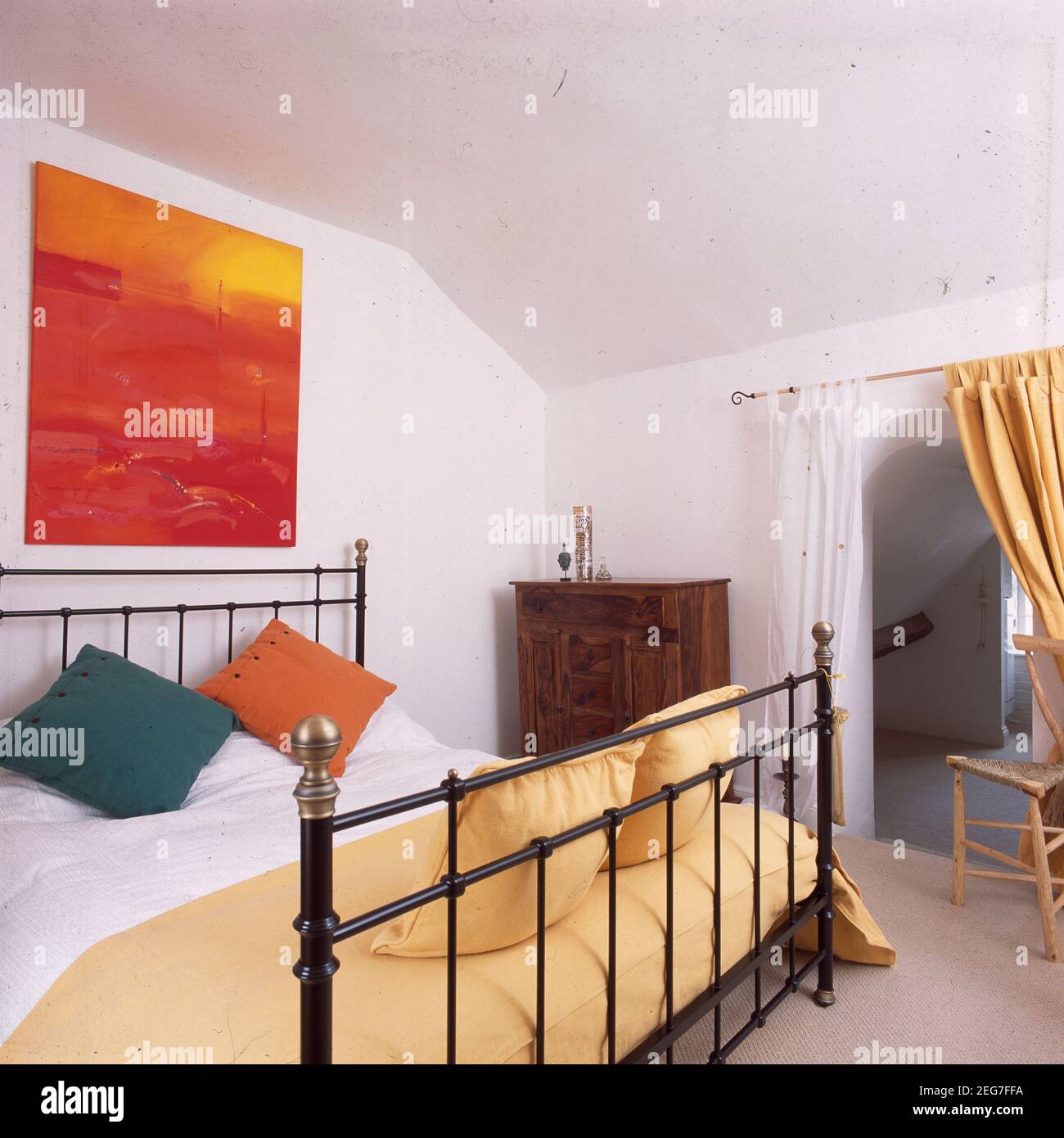 White painted attic room with metal double bed Stock Photo Alamy