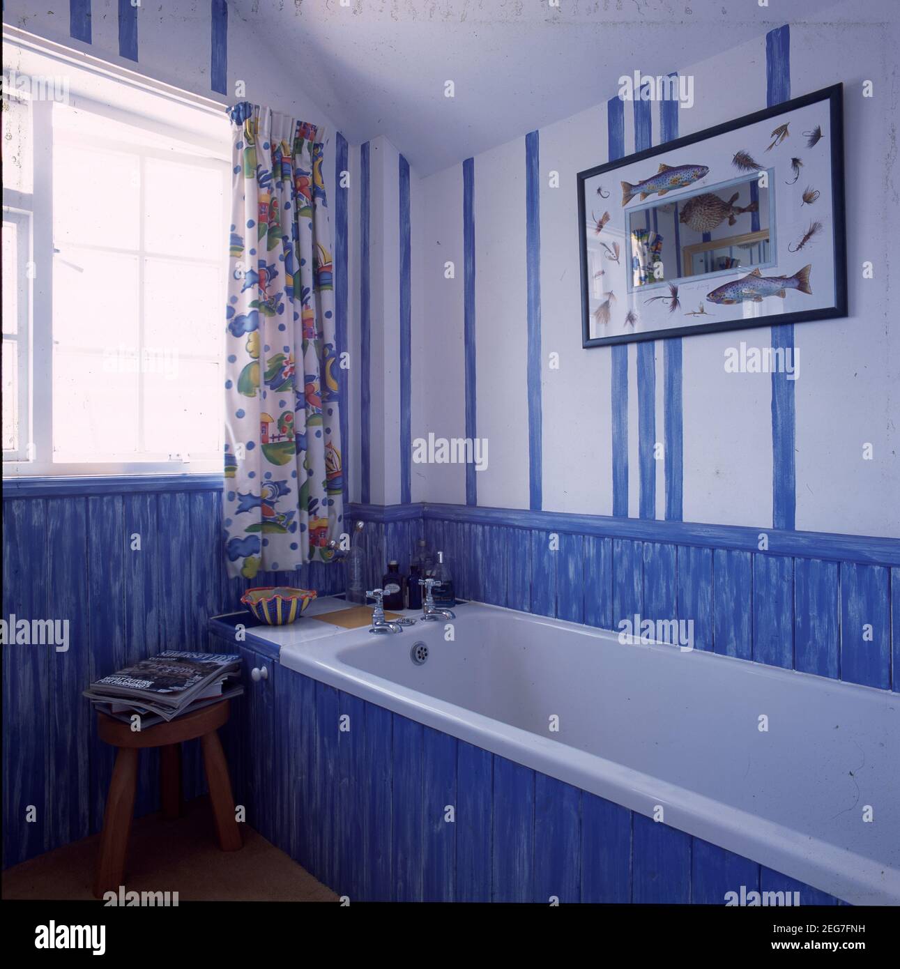 Blue and white bathroom with wooden panels to dado rail Stock Photo