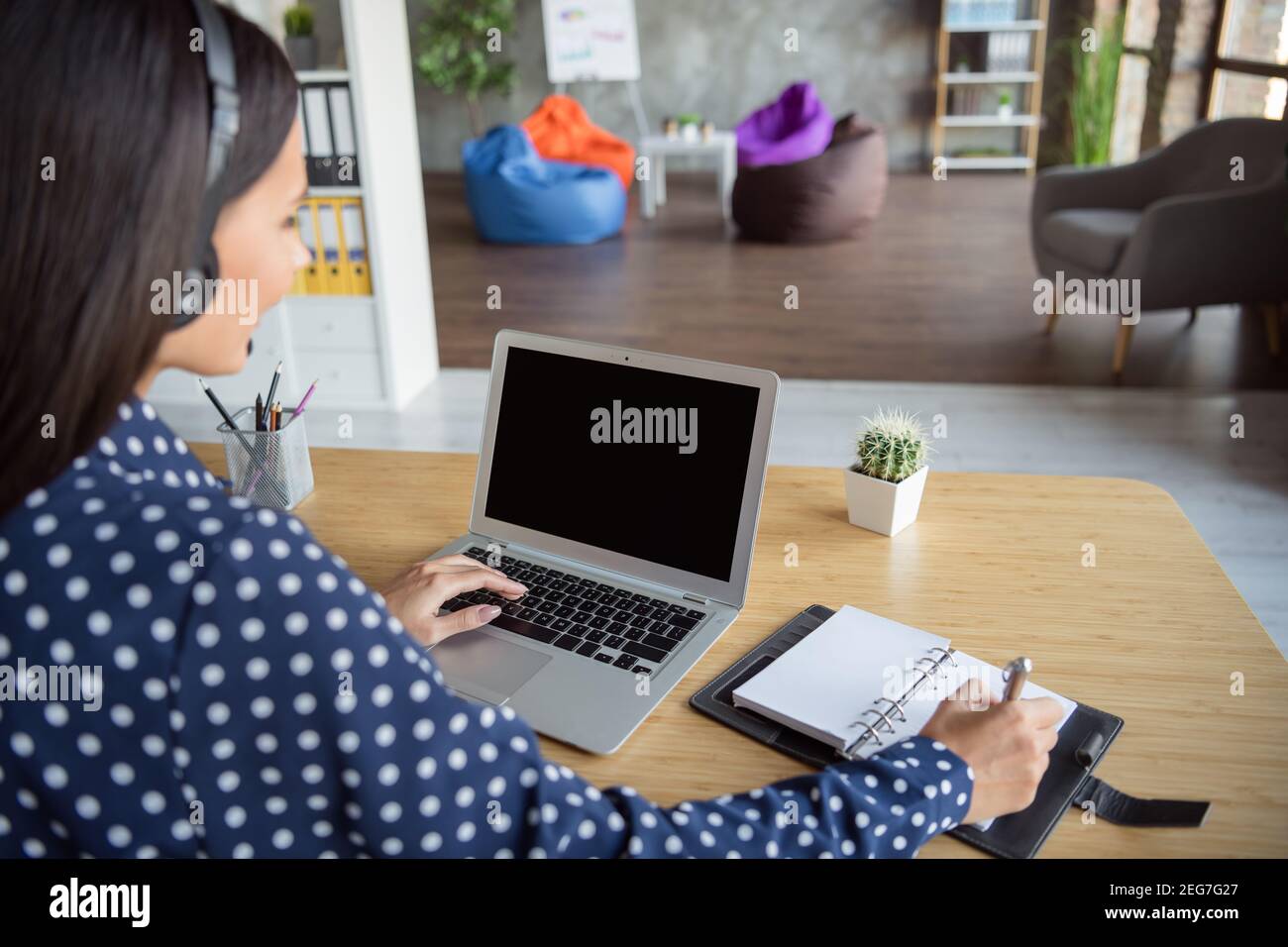Cropped photo of young businesswoman in headphones working typing in ...