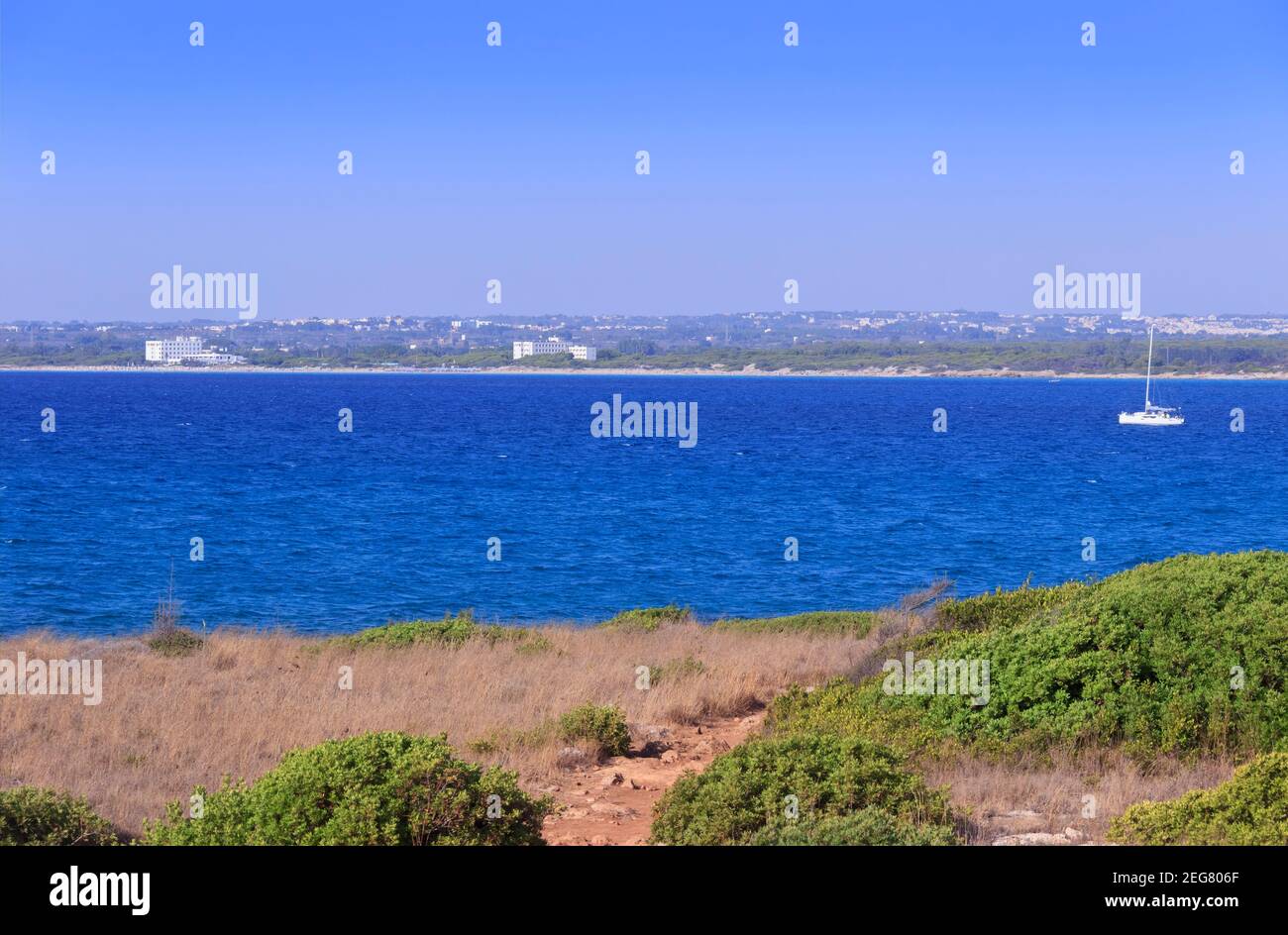 The rocky coast  the sandy beach and the sea of Baia Verde beach  in Salento, Apulia (Italy). Stock Photo