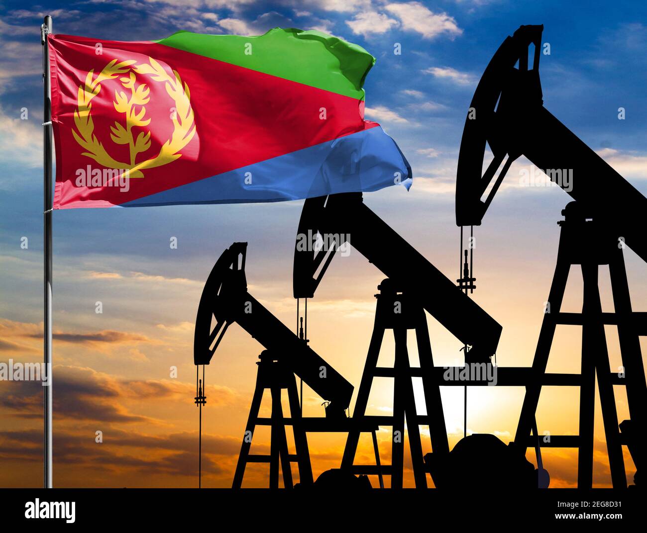 Oil rigs against the backdrop of the colorful sky and a flagpole with