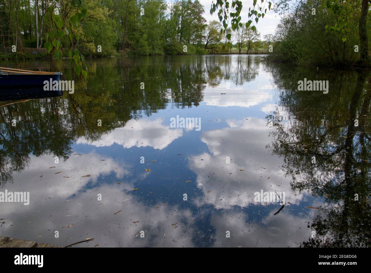 Reflection of the clouds and trees in the Hücker Moor near Spenge, Bünde in East Westphalia. Stock Photo