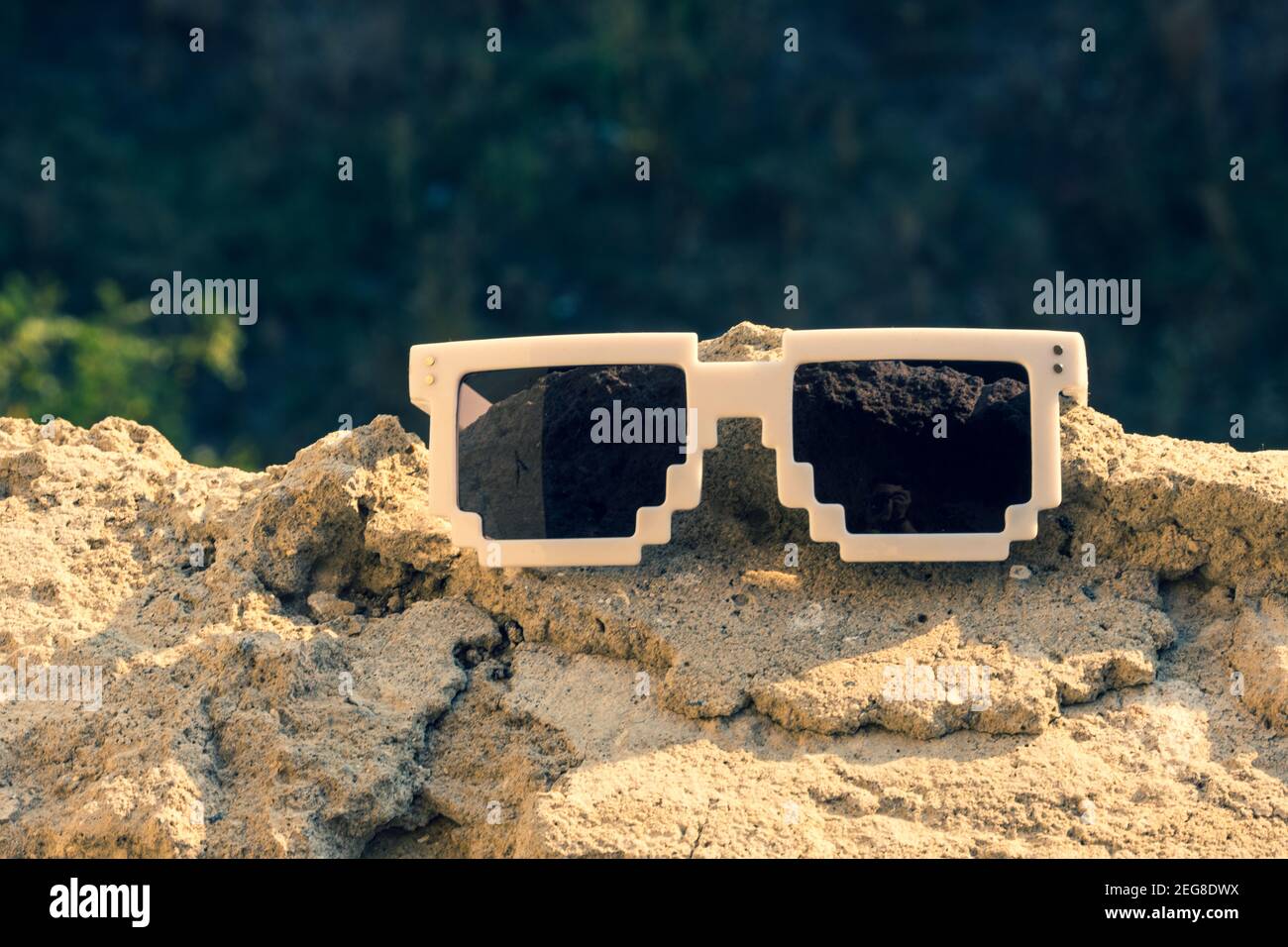 White pixel sunglasses with black lenses closeup in a sunny day. Selective focus Stock Photo - Alamy