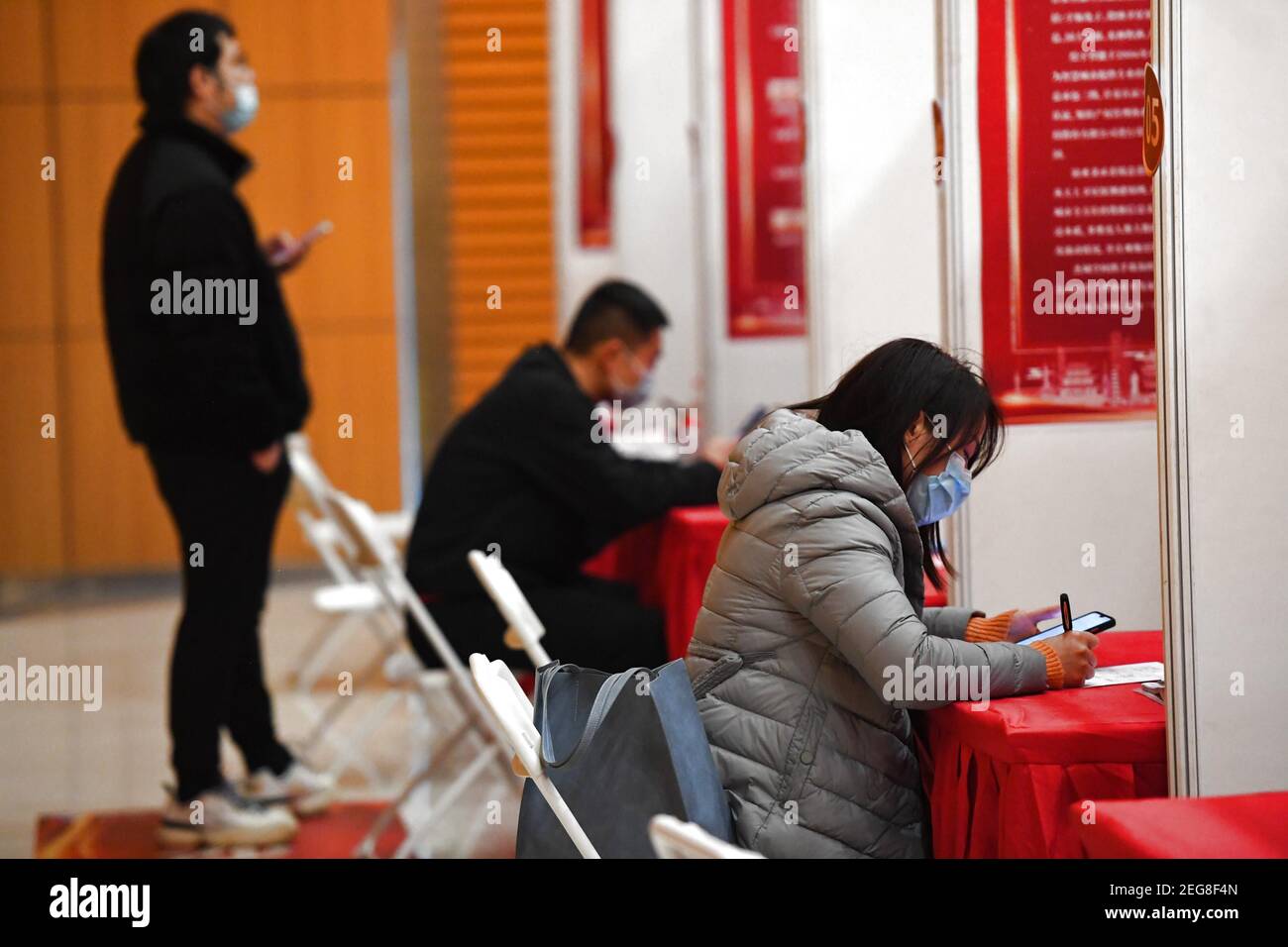 Changsha, China, 18 Feb 2021: Applicants fill in personal information sheets before interviews on a job fair at the Tianxin cultural industry park in Changsha, central China's Hunan Province, Feb. 18, 2021. The job fair, sponsored by the authority of Tianxin District of Changsha with assistance from authorities of Shifeng District of Zhuzhou City and Yuetang District of Xiangtan City, all in Hunan, took place in both on-line and off-line forms, and covered a variety of sectors such as software, culture and advertisement, smart manufacturing, and medicine and health. (Xinhua/C Credit: Xinhua/Al Stock Photo