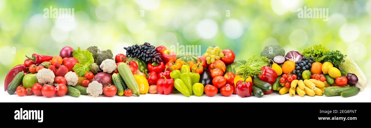 Panoramic photo multi-colored fruits and vegetables on green blurred background Stock Photo