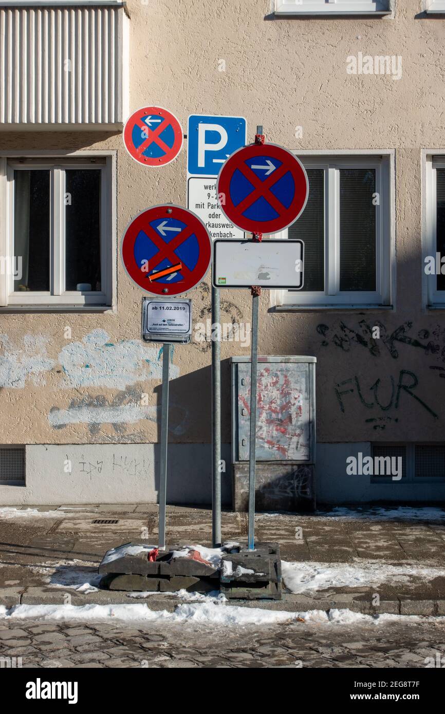 Munich, Germany - February 13, 2021: A mess of no parking signs standing in the residential area. The way the signs were installed could cause confusi Stock Photo