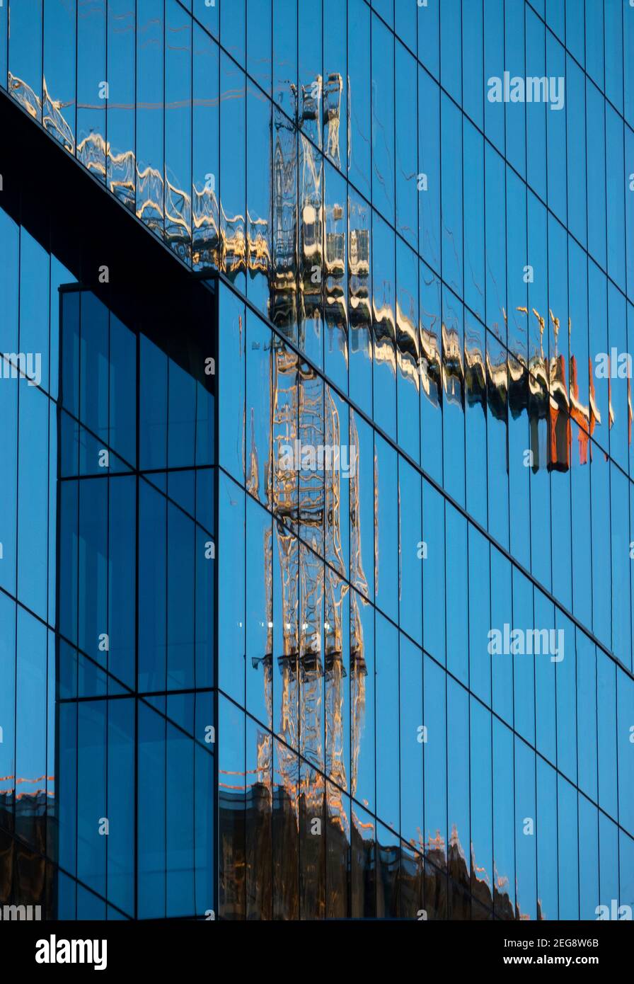 USA Maryland MD Bethesda Construction crane in the reflection of a new office building tower Stock Photo