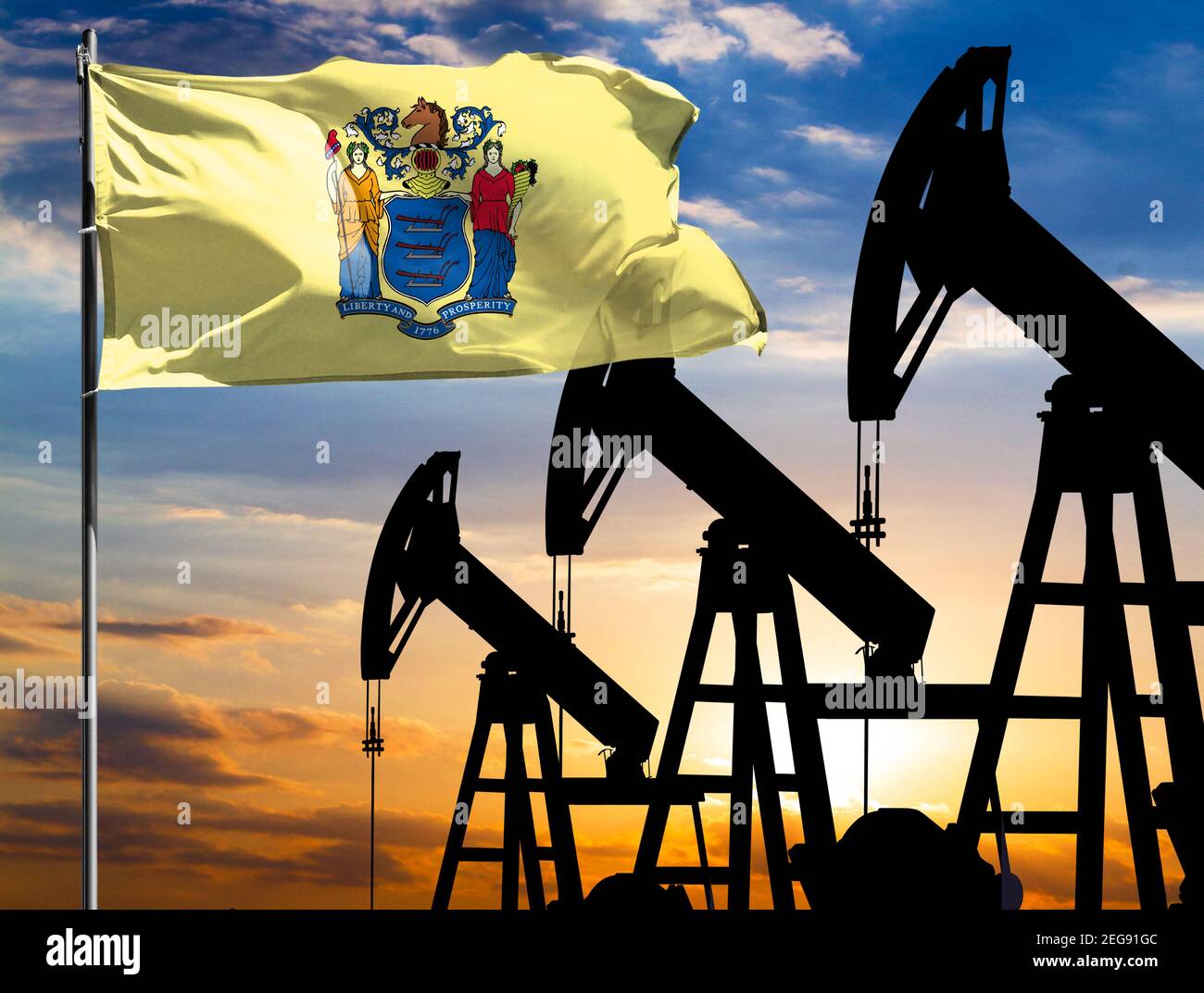 Oil rigs against the backdrop of the colorful sky and a flagpole with